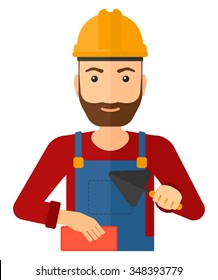 Una sonriente capa de ladrillo hipster con una espátula y un ladrillo en las manos vectorial ilustración de diseño plano aislado en fondo blanco. Diseño vertical.