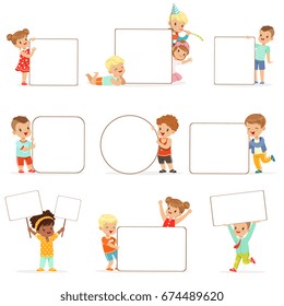 Smiling kids standing with white blank boards set. Happy little boys and girls in casual clothes holding empty posters vector illustrations