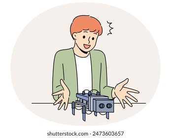 Smiling little boy creating robot. Happy small child sit at table designing robotic toy. Education and childhood. Vector illustration.