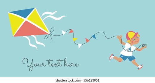 Smiling little boy running with kite on a sky blue background with space for your text.
