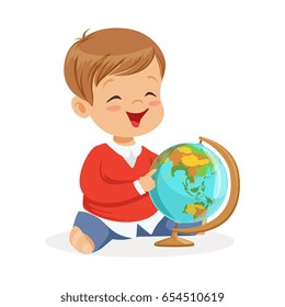Smiling little boy sitting and playing with globe. Child learning the world colorful cartoon character vector Illustration
