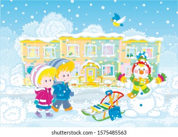 Smiling little kids going to their nursery school and looking at a funny snowman on a snow-covered playground of a winter park on a beautiful snowy day, vector illustration in a cartoon style
