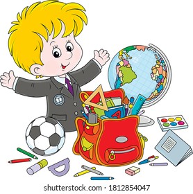 Smiling little schoolboy with rules, textbooks, exercise books, pencils, pens, a football, a globe and a school bag, vector cartoon illustration on a white background