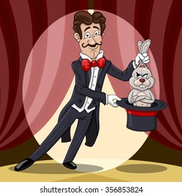 Smiling magician  pulls out a displeased rabbit from a hat against the stage curtains 