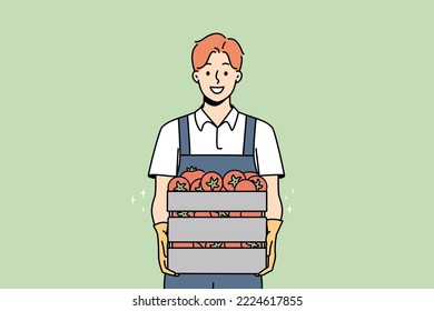 Smiling male farmer holding box of fresh tomatoes. Happy man gardener with baskets of vegetables from farm. Gardening and agriculture. Vector illustration. 
