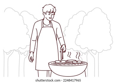 Smiling man in apron making meat on grill in park. Happy guy have fun cooking barbecue outdoors. Weekend and relaxation. Vector illustration. 