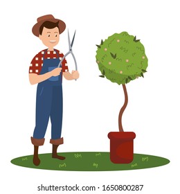 Smiling man in a checkered red-white shirt and blue overalls holding a pruning shears in his hands standing next to a green flower in pot. Isolated on white background. Vector stock illustration