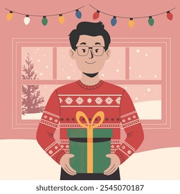 Smiling man holding a Christmas gift, wearing a red holiday sweater, standing in a cozy room with festive string lights and snowy windows.  
