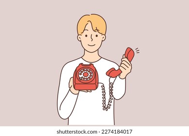 Smiling man holding retro landline phone offer to make call. Happy guy with corded telephone suggest talking. Vector illustration. 