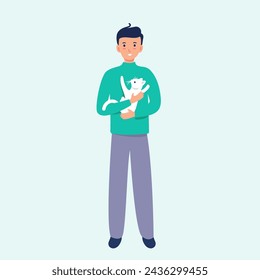 Smiling man with a kitten in his arms.