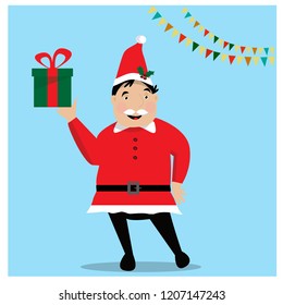 Smiling man in Santa red hat holding Christmas gift in hand. Christmas concept.
