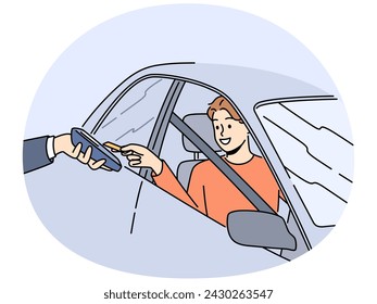 Smiling man sit at car pay with credit card on automatic reader. Happy male driver use car for payment on machine or terminal. Contactless payment. Vector illustration.