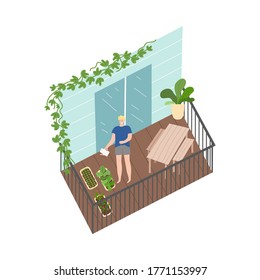 Smiling man standing on balcony and watering green plants with watering can