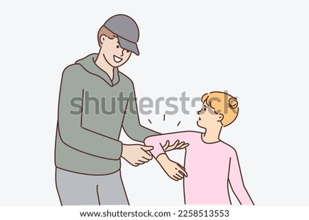 Smiling man trying to kidnap resisting teenage girl or commit kidnapping and child abuse. Displeased frightened schoolgirl trying to escape from hands of criminal kidnapping small children
