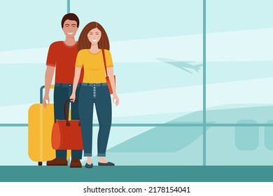 Smiling man and woman with luggage at the airport. 