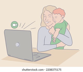 Smiling mother holding baby and doing video call. A woman sits at a table and makes a video call using a home laptop. Mom shows her little baby during an online meeting