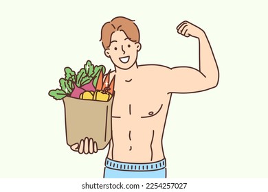 Un hombre musculoso sonriente con una bolsa llena de verduras frescas muestra biceps. Un atleta macho de tono feliz con comida orgánica sigue un estilo de vida sano que hace deporte. Ilustración vectorial. 