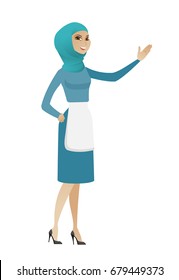 Smiling muslim cleaner standing with outstretched hand. Full length of young cleaner pointing at something and showing a direction by hand. Vector flat design illustration isolated on white background