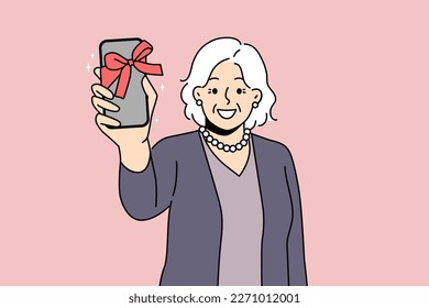 Smiling old woman show smartphone with bow as present. Happy mature grandmother excited with new cellphone gift. Elderly and technology. Vector illustration. 