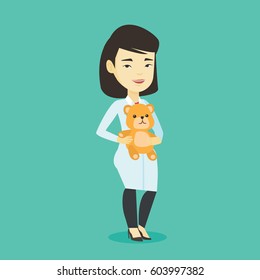 Smiling pediatrician doctor holding a teddy bear. Cheerful pediatrician doctor standing with a teddy bear. Young asian pediatrician in medical gown. Vector flat design illustration. Square layout.