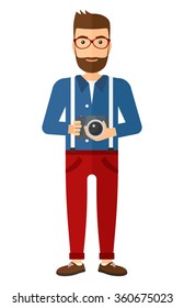 Smiling photographer holding camera.