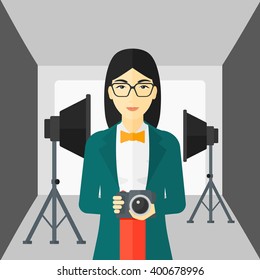 Smiling photographer holding camera.