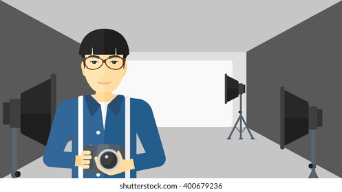 Smiling photographer holding camera.