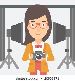 Smiling photographer holding camera.