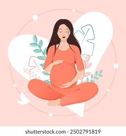 Smiling pregnant woman in orange dress in lotus pose tenderly holds her belly on floral background