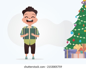 A smiling preschool boy stands and holds a box with a bow in his hands. New Year. Cartoon style. Vector illustration