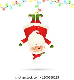 Smiling Santa Claus cartoon character hanging upside down with garland string of twinkle lights with multicolored bulbs isolated on white background. 