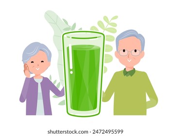 A smiling senior couple standing side by side with glasses of green juice between them. A positive image.