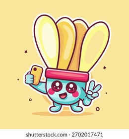 smiling shuttlecock character mascot taking a selfie with a smartphone isolated cartoon 