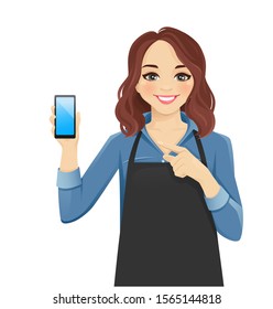 Smiling woman in apron showing blank screen phone isolated vector illustration