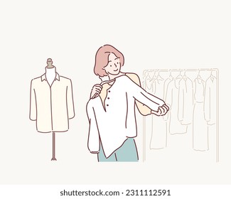 Smiling woman Choose and try on clothe white color in the Tailor shop. Hand drawn style vector design illustrations.