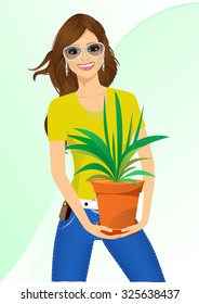 smiling woman with glasses holding chlorophytum in a pot