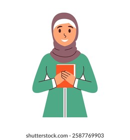 A smiling woman in a hijab gently holds a book close to her chest