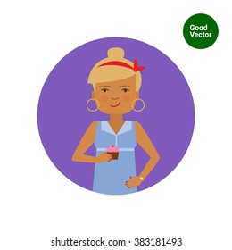 Smiling woman holding cupcake