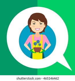 Smiling woman holding pot with flowers