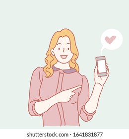 Smiling woman is pointing on smartphone. Hand drawn style, vector illustrations.