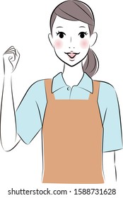 Smiling woman wearing an apron  raises hand fist.