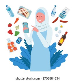 A smiling woman wearing hijab, groceries online shopping. She buys fruit, meat, vegetable, milk etc, through her cellphone.