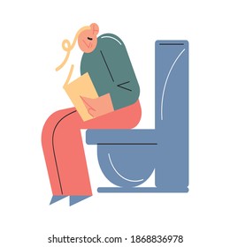 Smiling young boy sitting on toilet with book in hands and reading