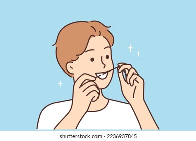 Smiling young man brushing teeth with dental floss. Happy guy take care clean tooth using thread. Oral care and dentistry. Vector illustration. 