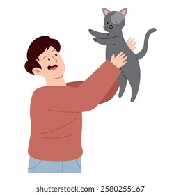 Smiling young man holding his pet cat high with affection