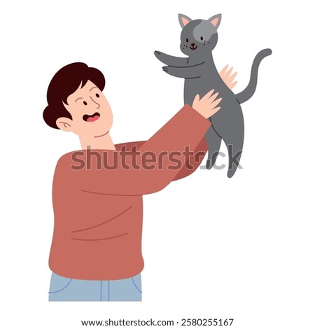 Smiling young man holding his pet cat high with affection