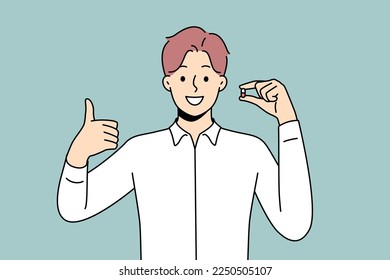 Smiling young man holding pill in hands showing thumb up. Happy male with tablet recommend treatment. Antidepressant or painkiller. Vector illustration. 