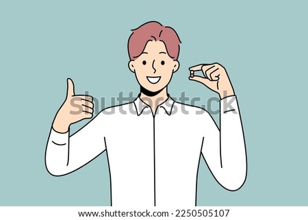 Smiling young man holding pill in hands showing thumb up. Happy male with tablet recommend treatment. Antidepressant or painkiller. Vector illustration. 