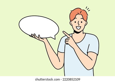 Smiling young man holding speech bubble in hands. Happy guy point at mockup empty blank copy space for advertising. Vector illustration. 