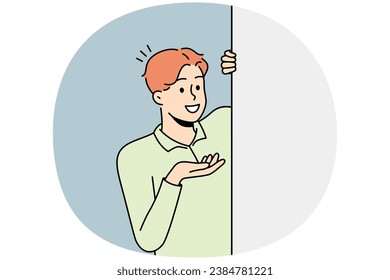 Smiling young man look behind mockup white poster show good deal or offer. Happy male recommend promotion on empty placard. Copy space. Vector illustration.